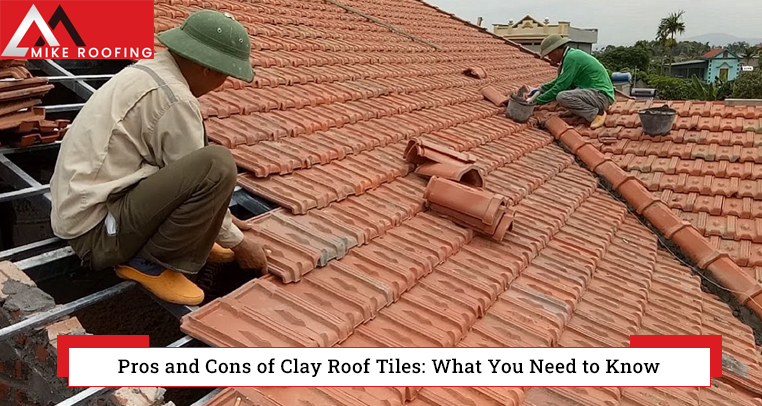 Workers installing clay roof tiles on a residential building.